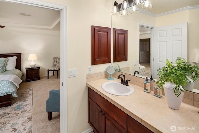 bathroom with connected bathroom, vanity, and crown molding