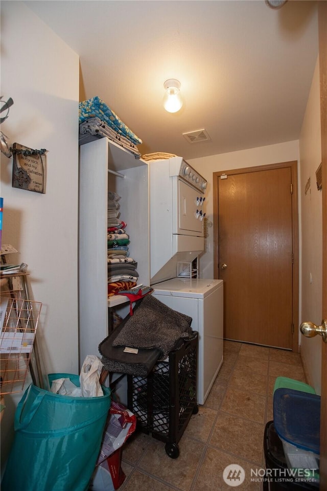 1431 Chatham Dr SE, Olympia, WA 98513 - laundry room featuring stacked washer / dryer and light tile patterned floors