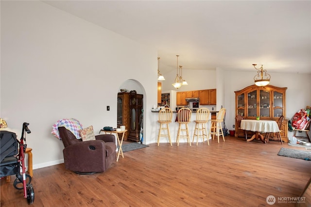 1431 Chatham Dr SE, Olympia, WA 98513 - living room with light wood-style floors, lofted ceiling, arched walkways, and baseboards