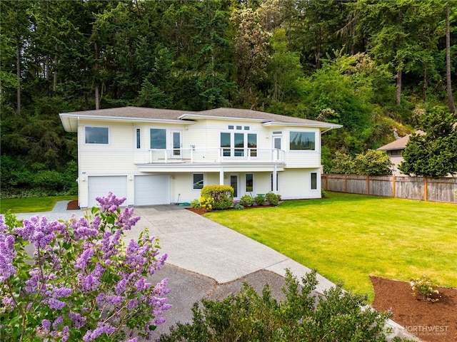 view of front of property with a balcony, a garage, and driveway