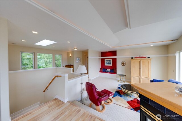 sitting room featuring recessed lighting, an upstairs landing, wood finished floors, and vaulted ceiling