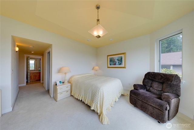 bedroom featuring light carpet and baseboards