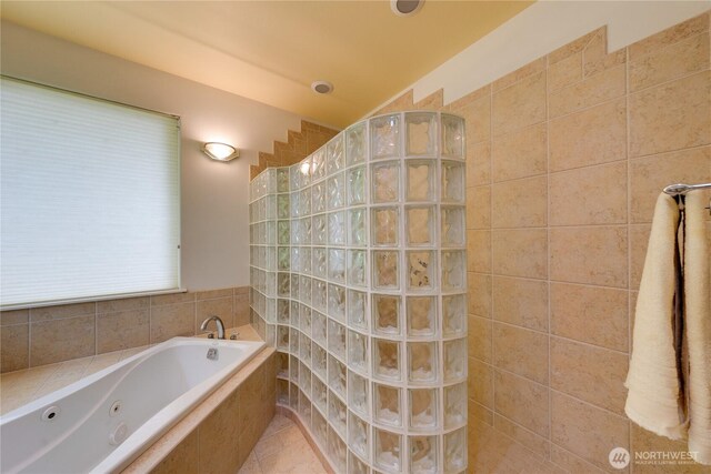 bathroom featuring walk in shower and a jetted tub