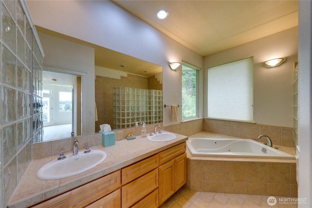 bathroom featuring a bath and double vanity