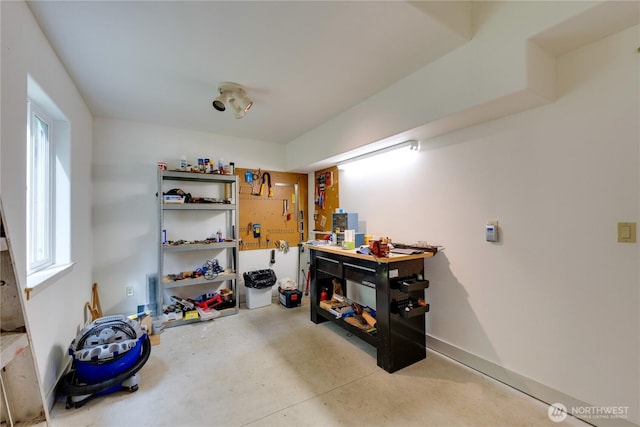 misc room with concrete floors and a workshop area