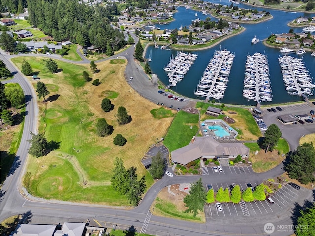 aerial overview of property's location featuring a large body of water and a marina