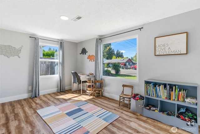 rec room with wood finished floors and baseboards