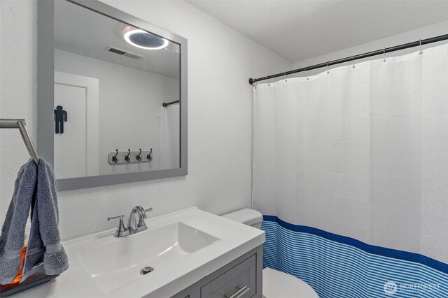 full bath featuring toilet and vanity