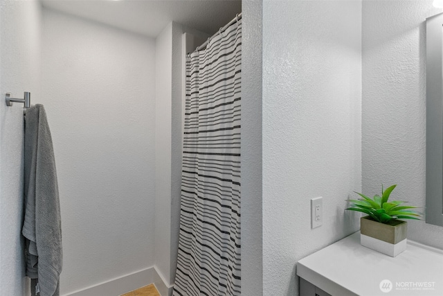 full bathroom with curtained shower and vanity