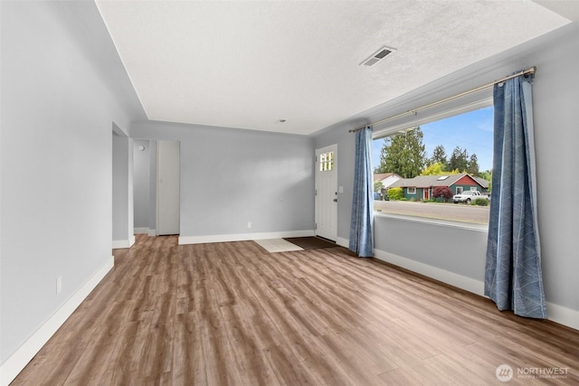 unfurnished room with wood finished floors and baseboards