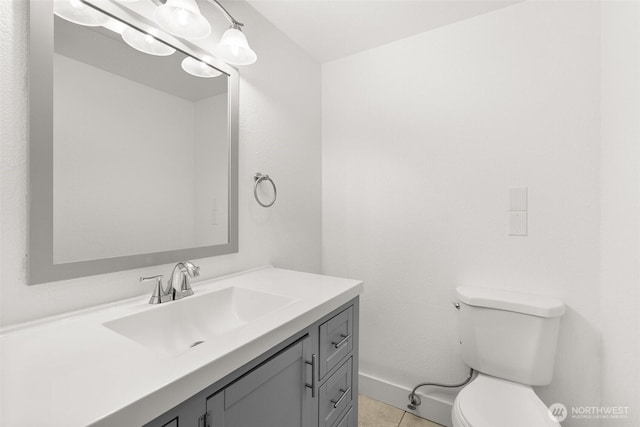 bathroom with vanity, toilet, and tile patterned flooring