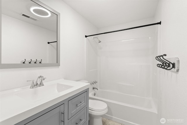 bathroom with shower / washtub combination, toilet, vanity, and tile patterned floors