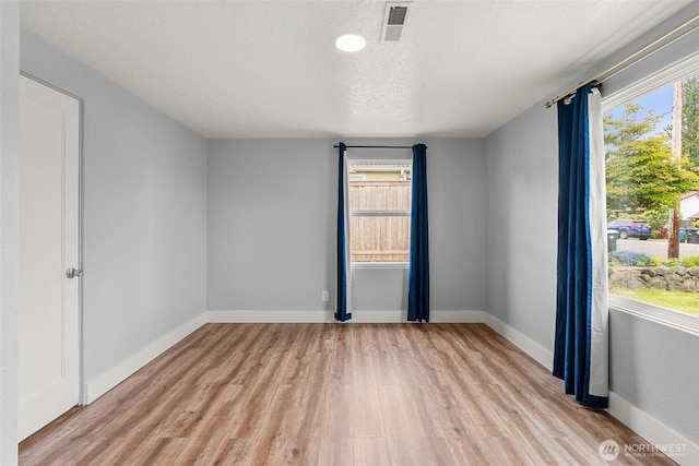 unfurnished room featuring light wood-type flooring and baseboards