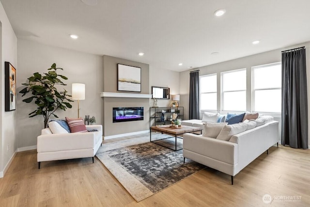 13213 164th Ave SE Unit 205, Renton, WA 98059 - living area featuring light wood-style flooring, baseboards, a glass covered fireplace, and recessed lighting