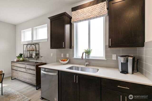 13213 164th Ave SE Unit 205, Renton, WA 98059 - kitchen with a sink, stainless steel dishwasher, tasteful backsplash, light countertops, and light wood-style flooring