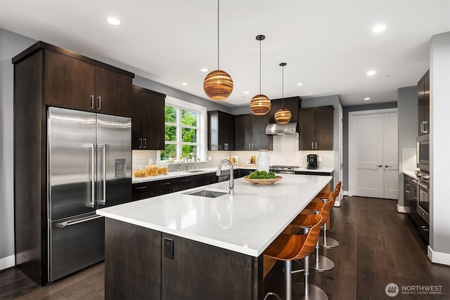 8326 84th Ave SE, Mercer Island, WA 98040 - kitchen with built in refrigerator, a sink, dark brown cabinets, light countertops, and recessed lighting