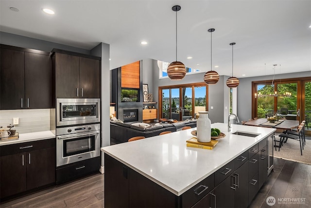 8326 84th Ave SE, Mercer Island, WA 98040 - kitchen featuring stainless steel appliances, a sink, light countertops, dark wood-style flooring, and recessed lighting