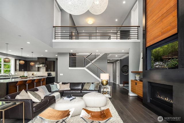 8326 84th Ave SE, Mercer Island, WA 98040 - living area with a high ceiling, dark wood-style flooring, stairway, recessed lighting, and a glass covered fireplace