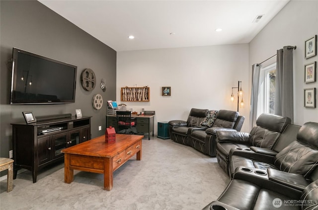 living area featuring light colored carpet and recessed lighting