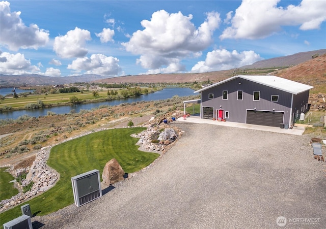 view from above of property with a water and mountain view