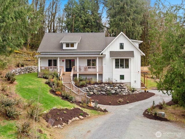 15403 127th Ave SE, Snohomish, WA 98290 - view of front of home featuring a porch, a front yard, stairway, driveway, and french doors