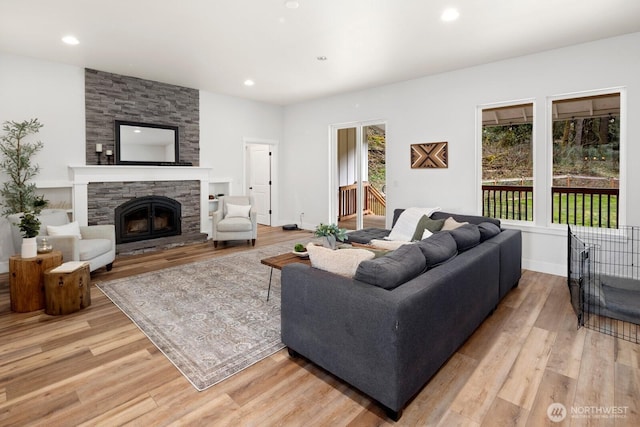 15403 127th Ave SE, Snohomish, WA 98290 - living room with light wood-style flooring, a stone fireplace, recessed lighting, and baseboards