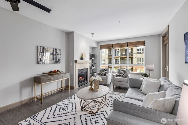 1840 25th Ave NE Unit 308, Issaquah, WA 98029 - living area with dark wood-style floors, a fireplace, baseboards, and a ceiling fan