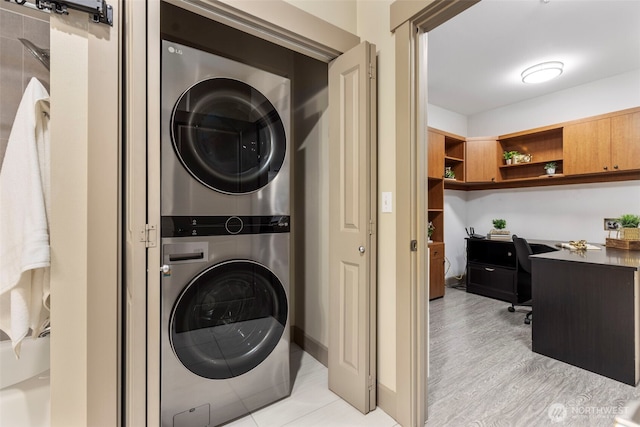 1840 25th Ave NE Unit 308, Issaquah, WA 98029 - washroom featuring estacked washer and dryer and a desk