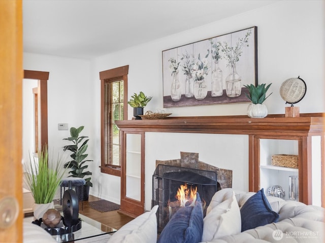 living area featuring a high end fireplace and wood finished floors