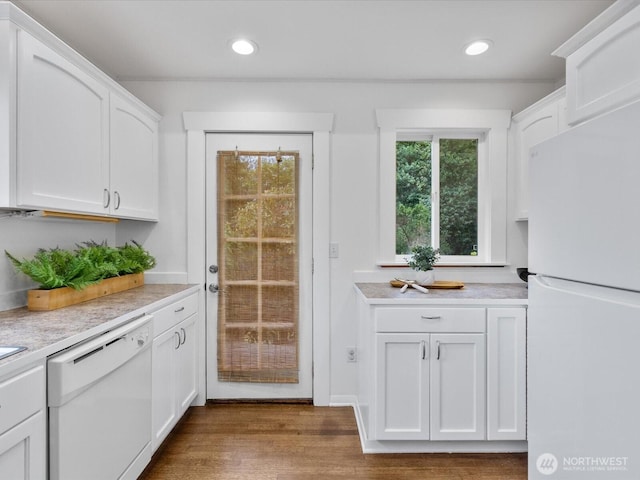 kitchen featuring white appliances, white cabinetry, light countertops, dark wood finished floors, and recessed lighting