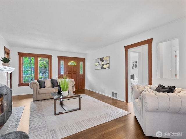 living room featuring wood finished floors and baseboards