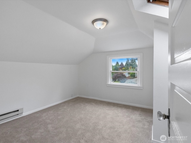 additional living space featuring carpet flooring, lofted ceiling, baseboard heating, and baseboards