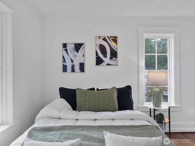 living room with crown molding, wood finished floors, and baseboards