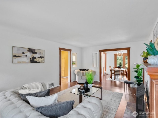 living room featuring a chandelier and wood finished floors