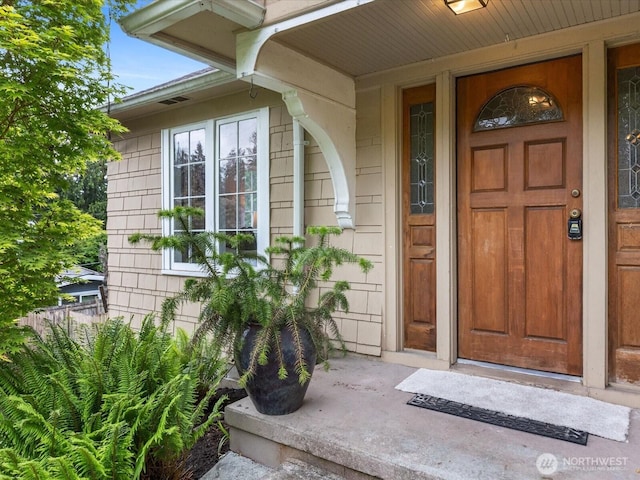 view of exterior entry featuring a porch