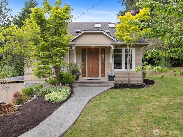 bungalow-style home with roof with shingles