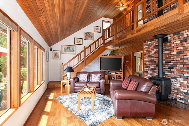 130 E Way To Tipperary St, Shelton, WA 98584 - living room featuring a wood stove, stairway, high vaulted ceiling, hardwood / wood-style flooring, and wood ceiling