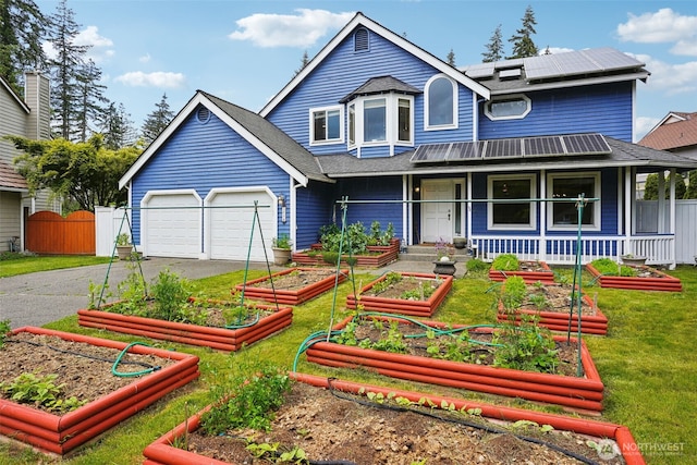 3008 S 365th Ct, Federal Way, WA 98003 - victorian house featuring driveway, covered porch, a garden, and solar panels