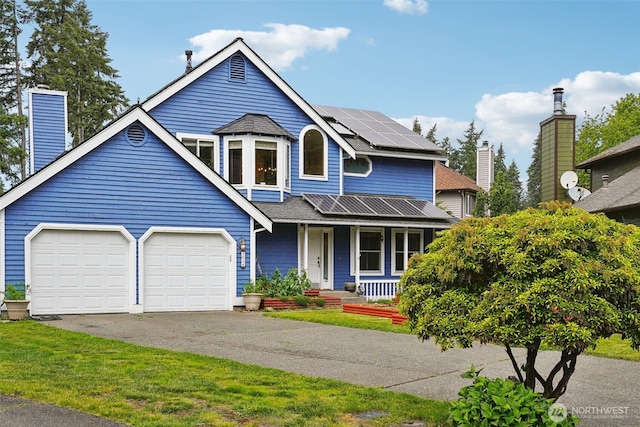 3008 S 365th Ct, Federal Way, WA 98003 - view of front facade with covered porch, driveway, a garage, solar panels, and a chimney