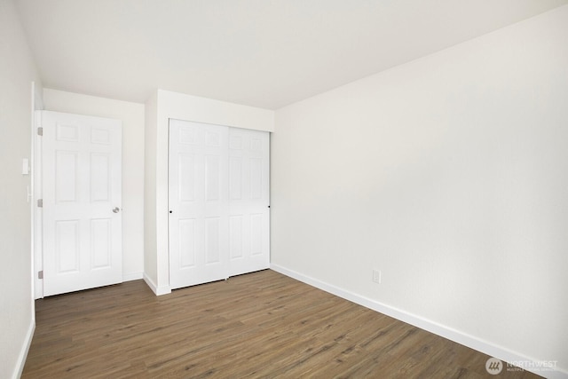 25735 115th Ave SE Unit J103, Kent, WA 98030 - unfurnished bedroom with wood finished floors, baseboards, and a closet
