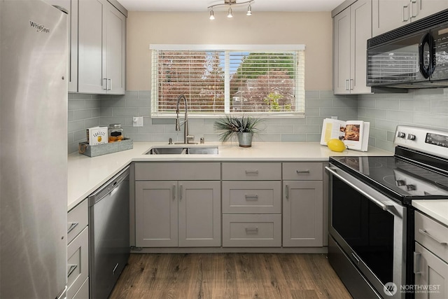 12024 101st Ave NE Unit E3, Kirkland, WA 98034 - kitchen with stainless steel appliances, gray cabinetry, backsplash, dark wood-type flooring, and light countertops