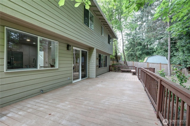 wooden terrace featuring a fenced backyard