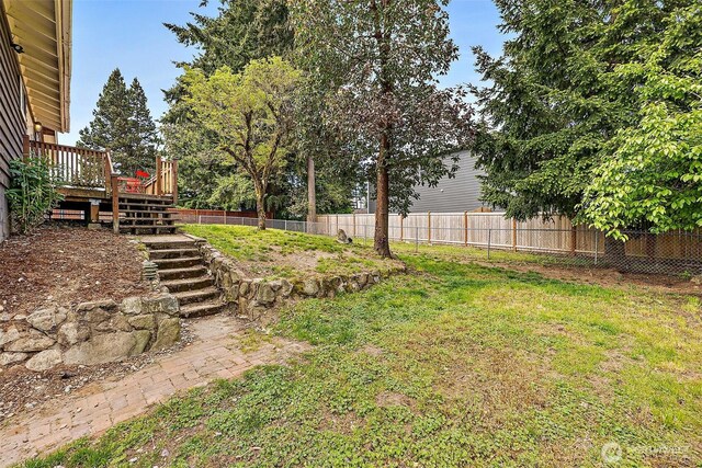 view of yard with stairs and a deck