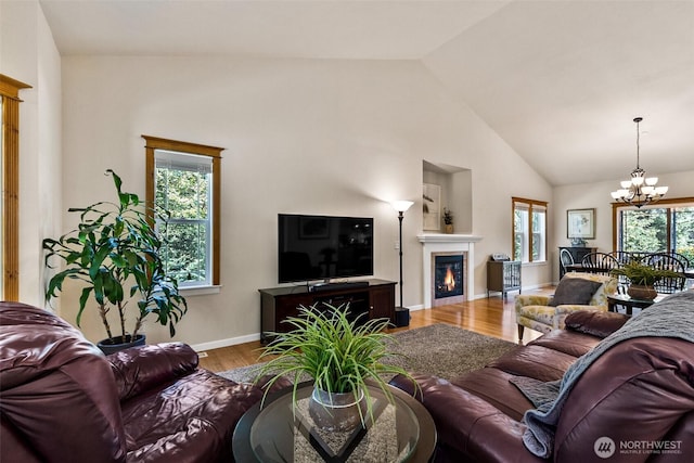 30830 NE 165th St, Duvall, WA 98019 - living area with a chandelier, wood finished floors, baseboards, a glass covered fireplace, and high vaulted ceiling