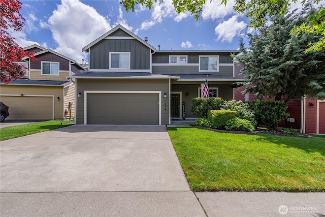 view of front of property featuring board and batten siding, a front lawn, driveway, and an attached garage