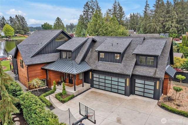 29108 218th Pl SE, Black Diamond, WA 98010 - view of front of house with board and batten siding, driveway, an attached garage, and roof with shingles
