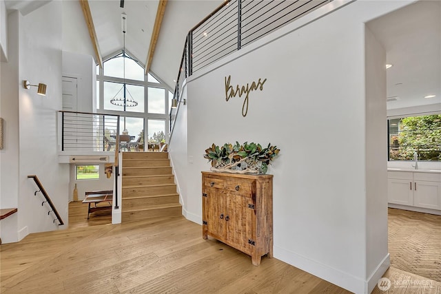 29108 218th Pl SE, Black Diamond, WA 98010 - staircase with beam ceiling, wood finished floors, a chandelier, recessed lighting, and baseboards