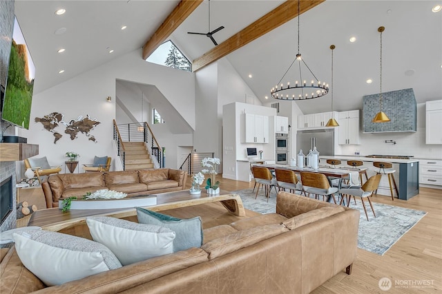 29108 218th Pl SE, Black Diamond, WA 98010 - living area featuring high vaulted ceiling, beamed ceiling, stairway, light wood-style flooring, and a chandelier
