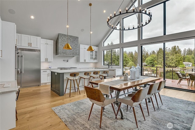 29108 218th Pl SE, Black Diamond, WA 98010 - dining room featuring high vaulted ceiling, light wood finished floors, and a chandelier