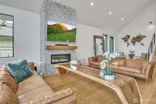 29108 218th Pl SE, Black Diamond, WA 98010 - living area featuring plenty of natural light, wood finished floors, a tile fireplace, high vaulted ceiling, and recessed lighting